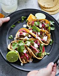 Pork Carnitas Tacos-Flour Tortillas, peppers, onions, tomatoes, lettuce, cheese, and chipo…